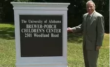 man outside standing by the university of alabama brewer-porch children's center