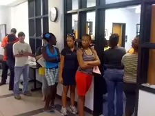 group of 10 college students waiting outside financial aid office 