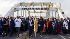 large group of people marching across Edmund Pettus Bridge in Selma